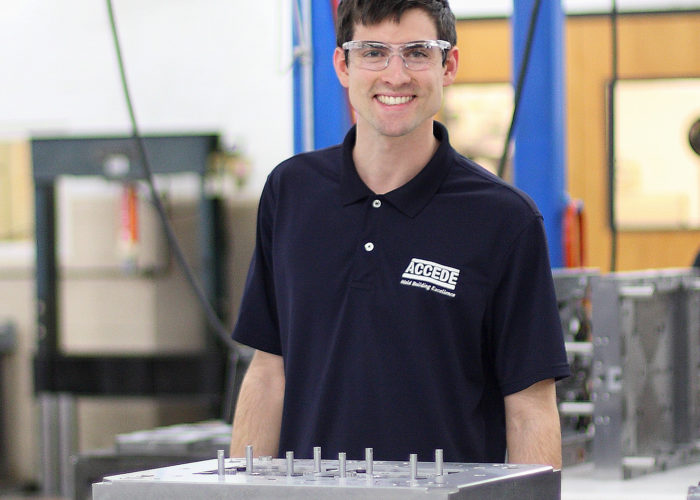 A man standing in front of some machines