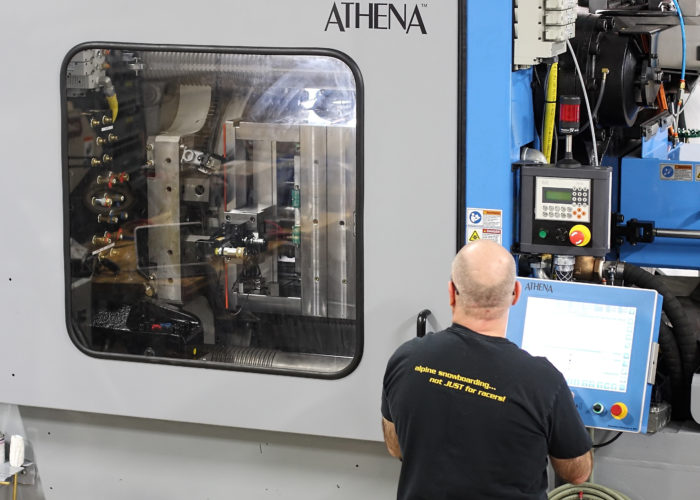 A man in black shirt looking at machine.