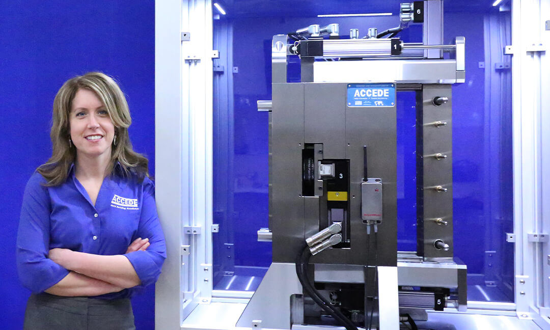 A woman standing next to an industrial machine.