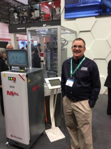 A man standing next to an exhibit at the convention.