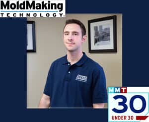 A man in blue shirt standing next to wall.